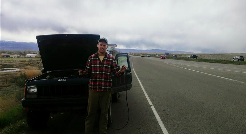 Bobby holds pieces of the broken serpentine belt, which left us stranded on a busy highway.
